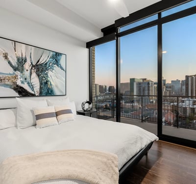 Inviting secondary bedroom with large windows, natural light, and clean modern finishes, perfect for guests or home office use.