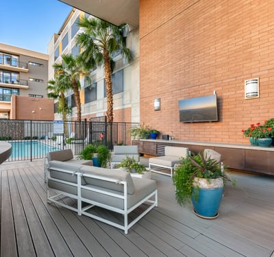Poolside retreat featuring lounge seating, grilling area, and landscaped surroundings, offering resort-style amenities in Phoenix.