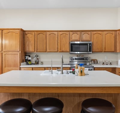 Bright kitchen and dining area with natural light, ample cabinetry, and open flow to living spaces in this Phoenix home.