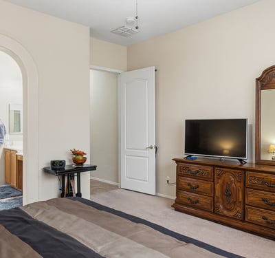 Well-sized primary suite with easy access to ensuite bath, providing comfort,