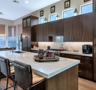 Elegant kitchen featuring a large island, quartz countertops, and high-end appliances, offering both beauty and performance in this Phoenix home.