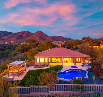 Stunning backyard retreat featuring pool, spa, pergola, and lush lawn, designed for Scottsdale outdoor living with panoramic mountain scenery.