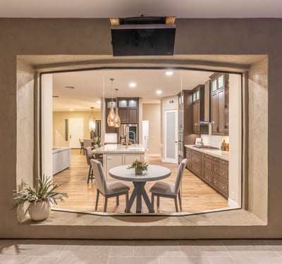 Elegant view into the modern kitchen with island seating, pendant lighting, and custom cabinetry, highlighting upscale Scottsdale interior design.