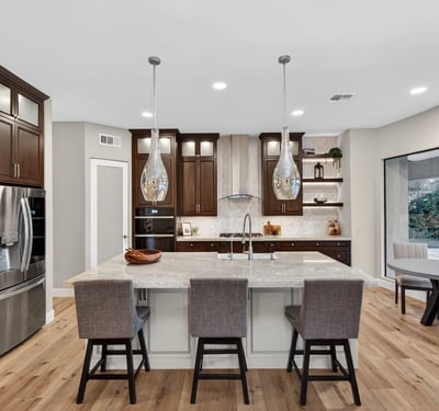 Light-filled kitchen with modern finishes, large island, and open layout connecting seamlessly to the Scottsdale living space.
