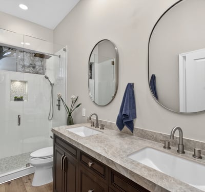 Modern Scottsdale bathroom featuring dual sinks, quartz counters, and a sleek glass shower with updated fixtures.