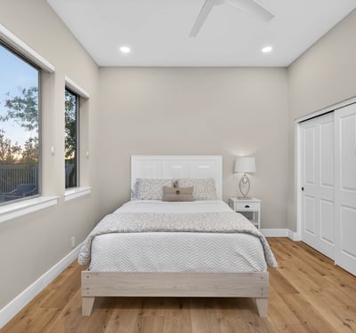 Spacious Scottsdale bedroom featuring ample closet storage, wood flooring, and natural light for everyday comfort.