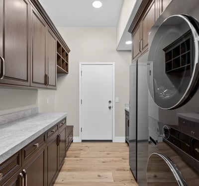 Functional Scottsdale laundry area with upper cabinets, utility sink, and durable countertops for everyday use.