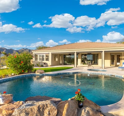 Scottsdale backyard featuring spa, pool, and expansive patio space with desert views, perfect for entertaining and relaxation.