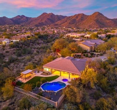 Scottsdale aerial view highlighting the backyard with pool, spa, and landscaped yard, offering privacy and desert surroundings.