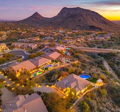 Scottsdale aerial showing the neighborhood at sunset with desert landscaping, homes, and warm evening lighting.