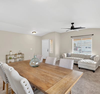 Flexible dining and living area with neutral tones and natural light. Open-concept layout enhances everyday living and entertaining in this Casa Grande home.
