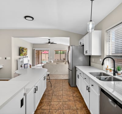 Well-designed kitchen with ample cabinets, stainless appliances, and extended counters. Open flow enhances functionality in this Casa Grande property.