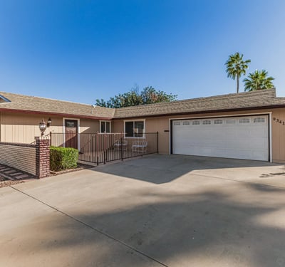 Wide driveway with attached two-car garage and private patio entry. This Sun City home combines convenience, functionality, and well-maintained exterior features.