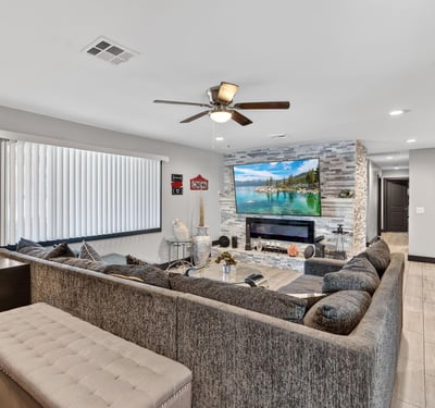 Updated living space with sleek fireplace, neutral palette, and modern finishes, offering comfort and style in this Phoenix home.