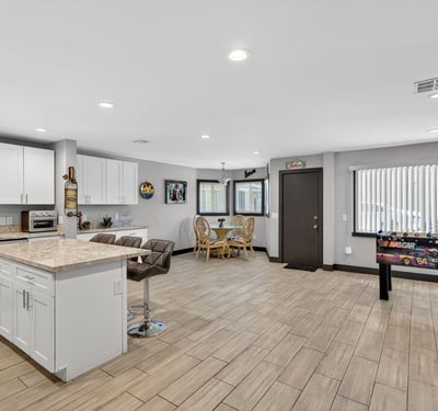 Expansive open-concept space with updated kitchen, modern flooring, and ample room for gathering, perfect for today s Phoenix lifestyle.