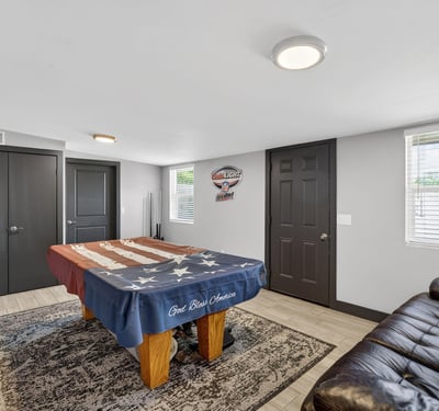 Large recreation room featuring a pool table and seating, offering a dedicated space for relaxation and entertainment.