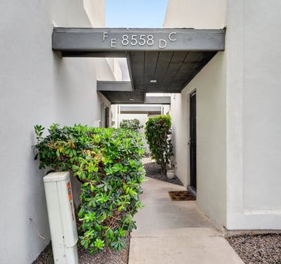 Quiet Scottsdale entry courtyard with covered patio and desert landscaping provides a peaceful, low-maintenance outdoor space.