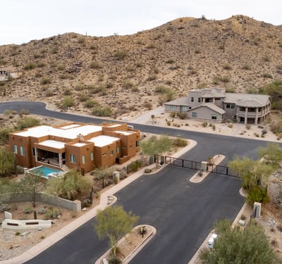 Secure gated entrance welcomes residents into an upscale hillside neighborhood surrounded by luxury custom homes and scenic desert landscapes near South Mountain Preserve.
