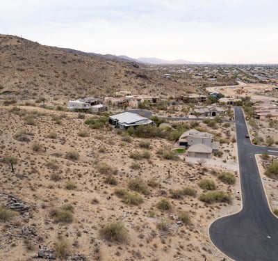 Wide panoramic aerial view capturing stunning desert landscapes, valley scenery, and hillside surroundings. This luxury Phoenix homesite offers privacy, views, and custom home potential in a scenic setting.