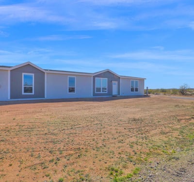 Exterior perspective highlighting the home's expansive acreage and scenic desert surroundings. The large lot provides privacy, flexibility, and room to create the lifestyle you've always wanted.