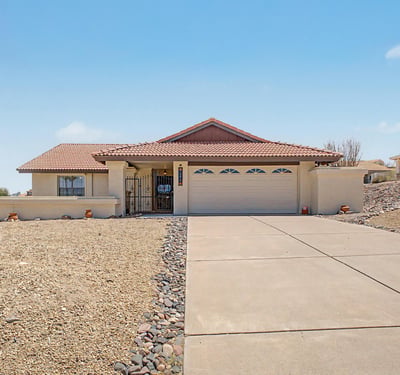 Attractive single-level residence showcasing classic Arizona architecture, a spacious driveway, and low-maintenance desert landscaping. This Fountain Hills property offers beautiful curb appeal and mountain-view surroundings.