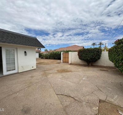 Open patio space offers a welcoming environment for outdoor gatherings, grilling, or relaxing evenings. Privacy walls and established landscaping create an enjoyable extension of the home's living space in Glendale.