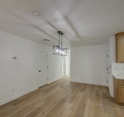 Contemporary lighting, fresh finishes, and an open floor plan make this dining room a welcoming space for casual meals, holiday gatherings, and everyday living.