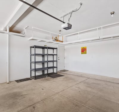 This oversized garage includes built-in overhead storage racks, shelving, and plenty of room for vehicles, hobbies, and equipment. An organized and practical feature that adds value to this Chandler property.