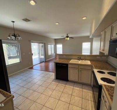 This bright kitchen connects seamlessly to the family room and covered patio, providing an ideal layout for entertaining while offering generous prep space and storage.