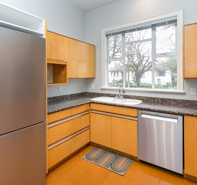 Bright and functional kitchen featuring modern appliances, ample storage, and a convenient window for natural light.
