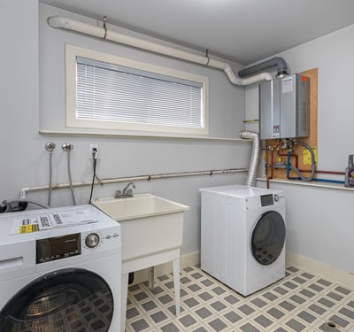 Bright laundry room featuring modern appliances, ample storage, and convenient hookups for all your laundry needs.
