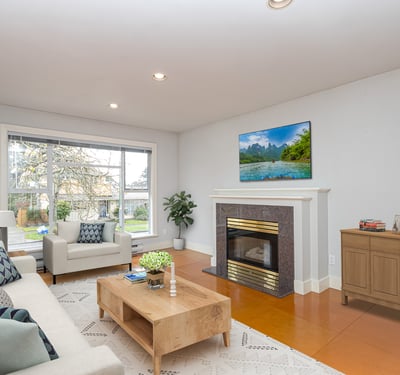 Bright and spacious living room featuring a modern fireplace and large windows for natural light.