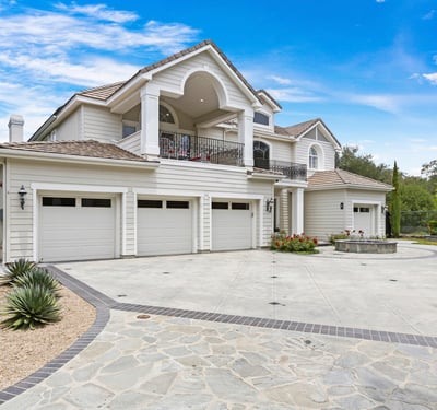 Stunning Oak Knoll Summit home featuring 4 spacious garages and beautifully landscaped grounds, perfect for entertaining and outdoor living.
