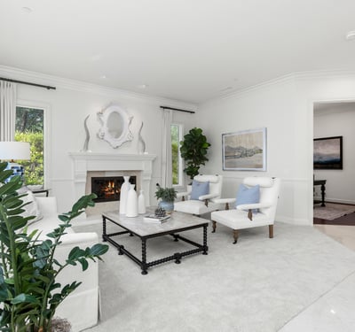 living space features a cozy fireplace and large windows, perfect for relaxation and gatherings.