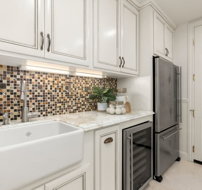 Modern Laundry room featuring a unique mosaic backsplash, spacious sink, and upgraded stainless steel appliances (Fridge and Wine Fridge included)