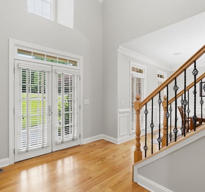 Welcoming foyer features modern design and abundant natural light, leading to an open dining area.