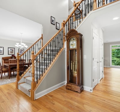 Discover a spacious entryway leading to a bright dining area, complemented by stunning wood details.