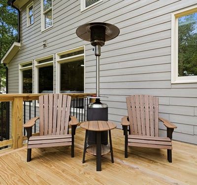 Cozy outdoor space featuring comfortable seating and a patio heater, perfect for year-round relaxation.