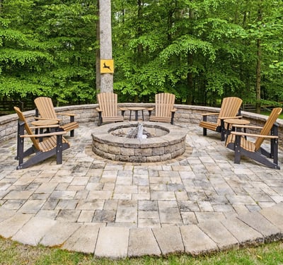 Inviting fire pit area surrounded by nature, perfect for gatherings and cozy evenings outdoors.