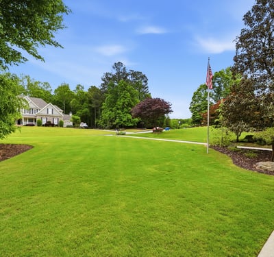 Expansive, well-maintained grounds offer ample space for outdoor activities and potential landscaping projects.