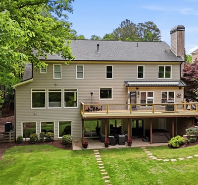 Spacious home with expansive outdoor living and large windows, perfect for enjoying the surrounding nature.