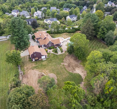 Spacious property with a large backyard, pool, and surrounding greenery, perfect for recreation and relaxation.