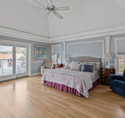 Spacious master bedroom with vaulted ceiling, private balcony access, and ample natural light. Perfect for relaxation.