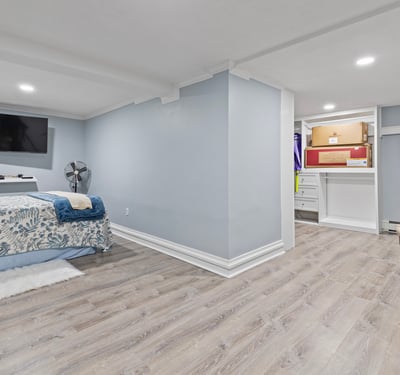 Spacious basement retreat featuring dual TVs, ample storage, and a cozy atmosphere for relaxation.