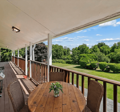 Spacious outdoor deck offers scenic views, perfect for relaxing or entertaining in a tranquil setting.
