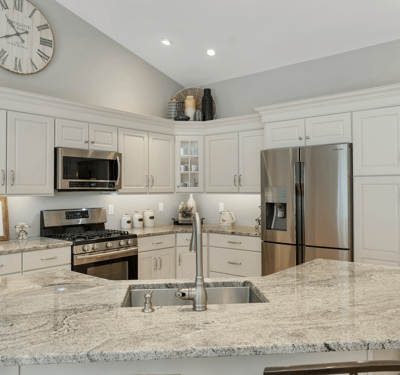 Modern kitchen featuring granite countertops, stainless steel appliances, and plenty of cabinetry for storage.
