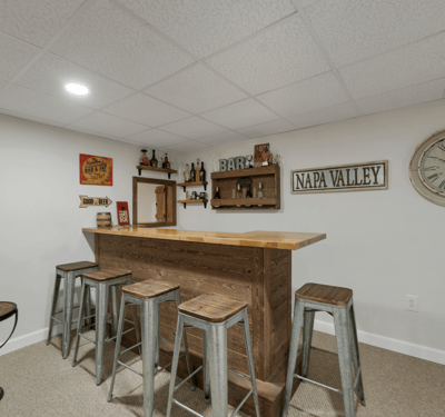 This versatile basement features a well-designed bar area, perfect for entertaining or relaxing with friends.