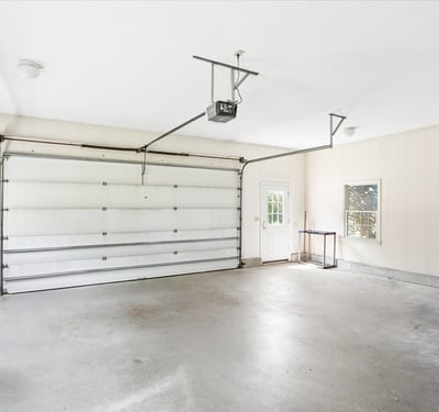 Spacious garage with ample storage and natural light, perfect for parking or a workshop area.