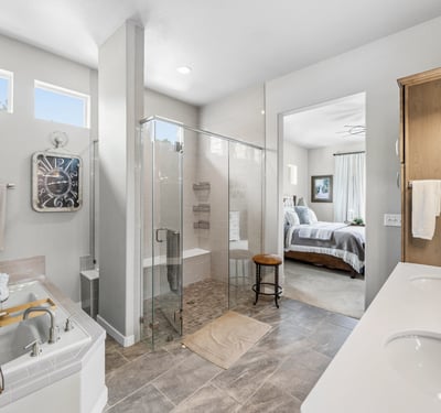 Primary Suite with attached 5 piece bath and walk in closet.