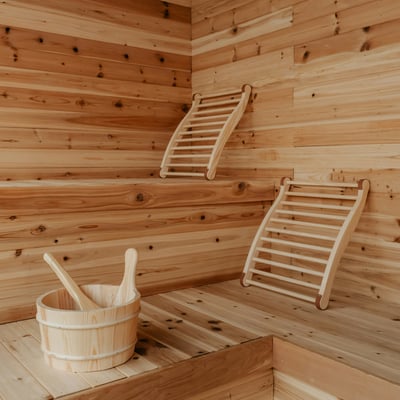 Experience this cozy sauna with warm wood tones and spacious seating for relaxation and rejuvenation.